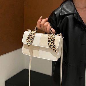 Minimalist beige crossbody square bag with leopard print scarf details and long strap