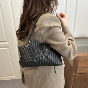 Retro black woven underarm bag for women with V-shaped texture and minimalist shoulder strap
