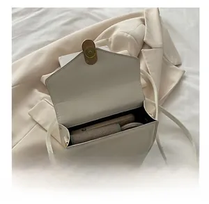 Internal view of white PU leather crossbody bag showing capacity for daily essentials