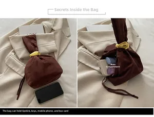 Detail of brown suede bucket bag with gold geometric ring and interior storage capacity