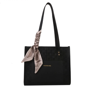 Elegant black woven tote bag with silk scarf decoration and gold fashion logo