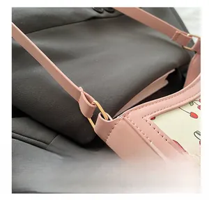 Detailed close-up of pink cherry print bag showing the metal link and quality stitching