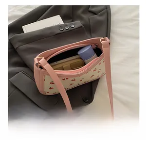 Interior view showing the storage capacity of the pink cherry print underarm bag
