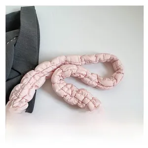 Detail of pink quilted cloud bag strap with soft padded wavy stitching design