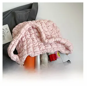 Detail showing high-capacity interior of pink quilted puffy bag with daily essentials