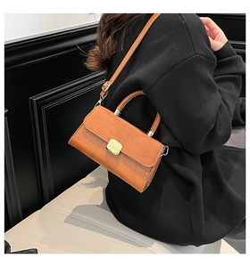 Caramel brown flap crossbody bag with golden square lock and leather texture details
