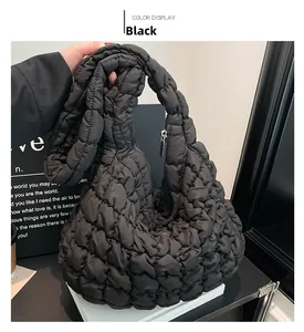 Detail of black quilted cloud bag showing soft padded texture and silver metal zipper