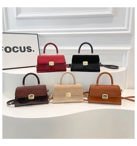 Detail view of colorful minimalist crossbody bags with vintage gold locks on stands