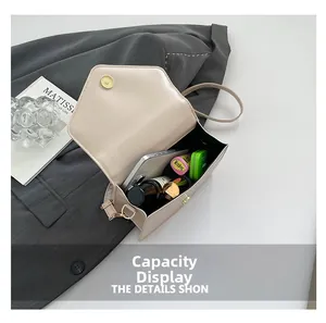 Internal view of the beige crossbody bag showing phone and cosmetics storage capacity
