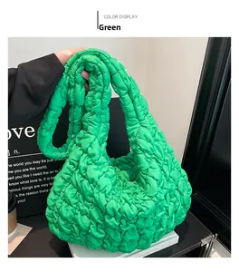 Detail view of bright green quilted hobo cloud bag with textured pleated nylon fabric