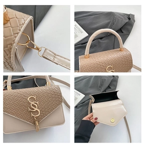 Detail view of beige crossbody bag showing S-shaped metal hardware and woven texture
