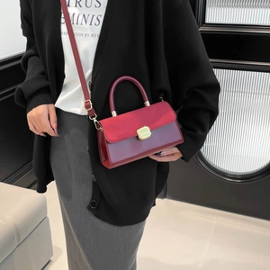 Elegant red contrast leather handbag with gold clasp and detachable shoulder strap
