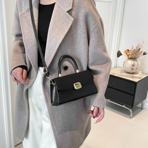 Classic black structured leather handbag for women with gold clasp and top handle