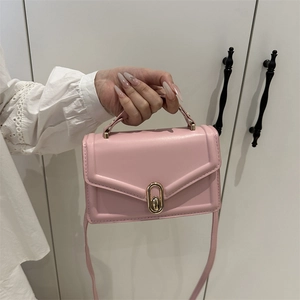 Pink minimalist crossbody square bag with gold metal twist lock and top handle