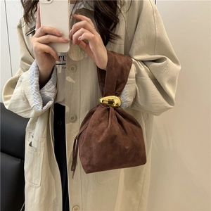 Brown suede drawstring bucket bag with gold liquid metal hardware and fringe detail