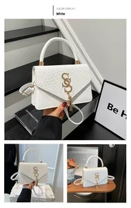 Detailed views of white crocodile pattern shoulder bag with gold S logo and tassel pendant
