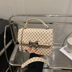 Vintage floral bow mini bag with silver chain strap shown in a modern lifestyle setting