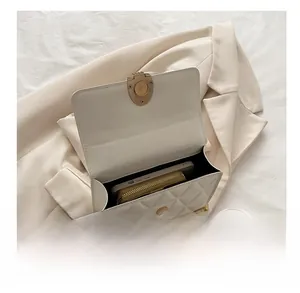 Interior view of white quilted chain bag showing capacity for phone and wallet