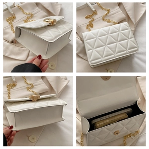 Macro view of white quilted crossbody bag with gold chain and interior storage space