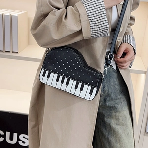 Unique piano shaped crossbody bag with black white keys and adjustable strap