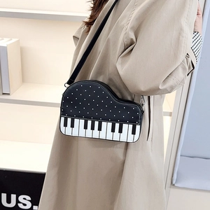 Chic piano-shaped crossbody bag with black white polka dots and piano key design