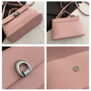 Vue détaillée de la texture tissée rose et des ferrures argentées d'un sac bandoulière