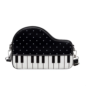 Creative piano-shaped shoulder bag with classic black and white keys and polka dots