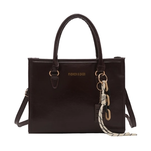 Dark brown faux leather tote bag with gold logo and decorative keychain charm