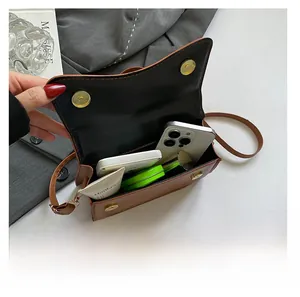 Interior view of brown leather crossbody bag showing large storage capacity for essentials