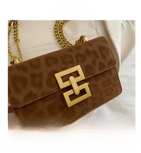 Détail de la texture léopard marron sur le sac avec chaîne dorée et fermoir métallique