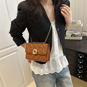 Brown quilted leather chain flap bag with gold horseshoe buckle for crossbody wear