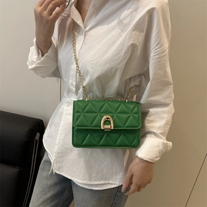 Elegant emerald green quilted chain bag with gold horseshoe clasp for crossbody wear