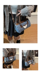 Detail of blue faux shearling mini bag featuring white heart patch and leather strap