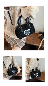 Detail of black lamb wool crossbody bag with heart patch and gold-tone hardware