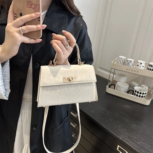 Chic beige crossbody commuter bag with gold twist lock and adjustable strap