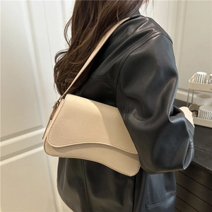 Minimalist off-white underarm bag with curved base and long shoulder strap for women