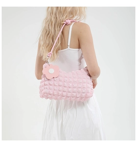 Detailed macro of pink bubble texture fabric with a cute floral charm on the strap