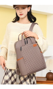 Détail du motif matelassé en losange sur le sac à dos professionnel gris avec cuir