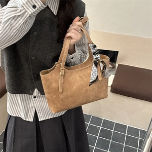 Brown vintage faux leather tote bag for women with floral scarf on a gold metal buckle