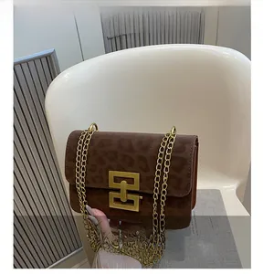 Detail of brown leopard print bag with gold interlocking buckle and chain strap