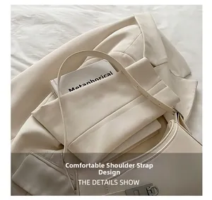 Close-up of comfortable shoulder strap with silver Gancini buckle on beige bag