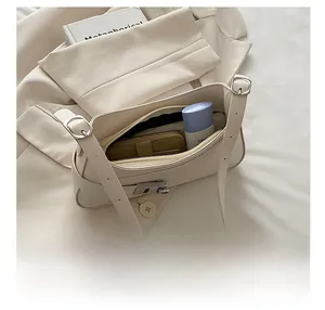 Interior view of cream underarm bag showing spacious storage for wallet and cosmetics