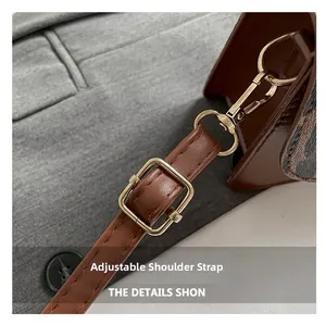 Detail of adjustable leather shoulder strap with gold metal buckle and spring hook