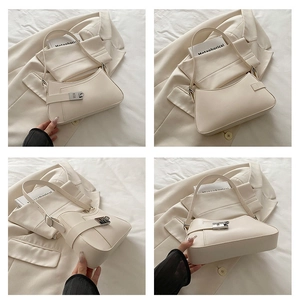 Detail view of beige hobo bag with silver buckle showing front, side and bottom design