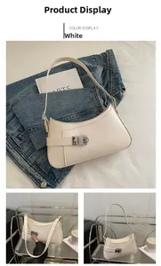 Close-up of white half-moon underarm bag featuring silver metal twist lock and minimalist design