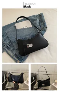 Detail view of black minimalist shoulder bag with silver square buckle and matte PU leather
