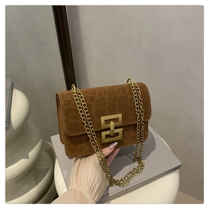 Detail of brown leopard print crossbody bag with gold geometric lock and chain strap