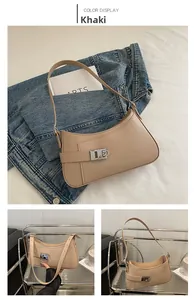 Detailed view of khaki crescent shoulder bag with silver buckle and adjustable strap