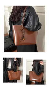 Detailed close-up showing the smooth texture and gloss finish of the brown leather tote bag
