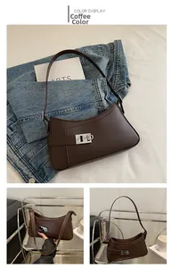 Detail view of coffee brown underarm bag featuring matte leather and silver square buckle